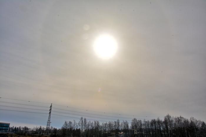 The sun shines through a layer of Altostratus clouds.